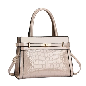 Beige faux crocodile skin leather handbag with glossy finish and metal buckle closure