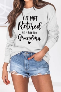 Detail of white cotton sweatshirt with black slogan print for grandmas and heart graphic