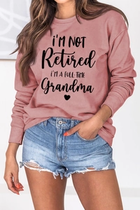 Detail of Grandma slogan print on dusty pink sweatshirt with a casual drop shoulder style