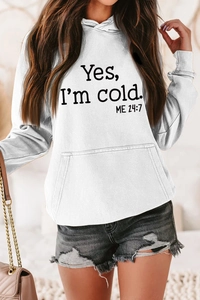 Detail of white oversized hoodie featuring 'Yes I'm Cold' slogan and kangaroo pocket