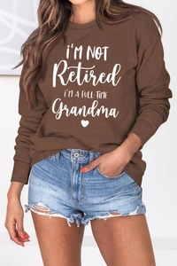 Detail of soft cotton sweatshirt featuring white I'M A FULL-TIME Grandma lettering