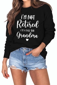 Detail of white cursive lettering print on black long sleeve crewneck sweatshirt for grandmas
