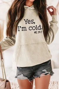 Detail of loose beige hoodie with black letter print and front kangaroo pocket