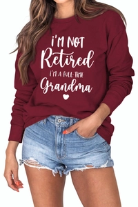 Detail of wine red sweatshirt with white I'M A FULL-TIME Grandma lettering and heart graphic