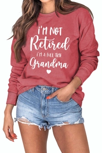 Detail of red crewneck sweatshirt with white I'M A FULL-TIME Grandma lettering and heart
