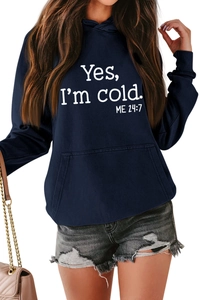Detail of dark blue hoodie showing Yes I'm Cold 24:7 text and kangaroo pocket texture