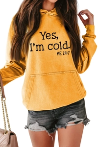 Detail of ginger yellow hoodie featuring Yes I'm Cold 24:7 print and kangaroo pocket