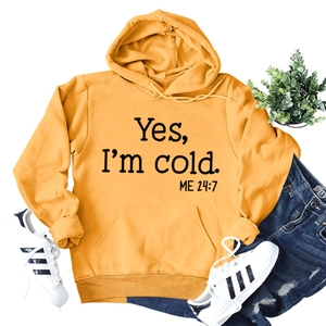 Detail of ginger yellow hoodie with black slogan print and ribbed sleeve cuffs