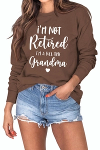 Detail of white slogan print on brown long sleeve sweatshirt for grandmothers