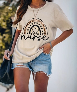 Close-up of beige nurse T-shirt with leopard rainbow heart print and denim shorts