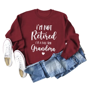 Close-up of I'M A FULL-TIME Grandma typography on a wine red long sleeve sweatshirt