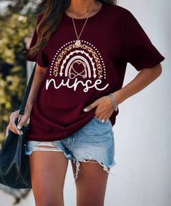 Close-up of nurse t-shirt with rainbow leopard heart print and stethoscope detail