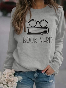 Close-up of Book Nerd print and glasses illustration on a grey round neck sweatshirt