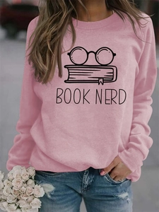 Detail of pink BOOK NERD sweatshirt showing the graphic print and cotton fabric texture