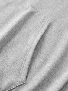 Dettaglio ravvicinato delle cuciture sulla tasca di una felpa grigio chiaro in maglia