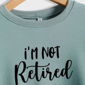 Sage green crewneck sweatshirt with 'i'm NOT Retired' graphic print for women