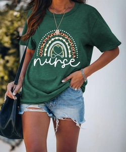 Detail of dark green nurse t-shirt with rainbow leopard heart print and denim shorts