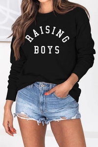 Close-up of RAISING BOYS letter print on a black long sleeve casual cotton sweatshirt
