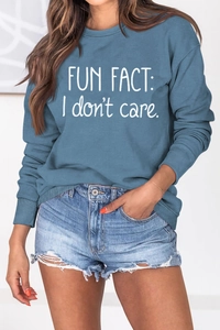 Detail of ribbed cuffs and white Fun Fact I Don't Care print on blue crewneck sweatshirt