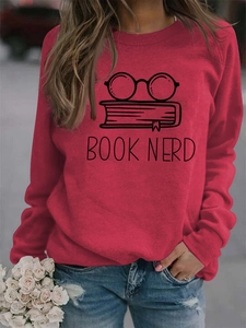Detail of red crewneck sweatshirt featuring black glasses and BOOK NERD graphic print