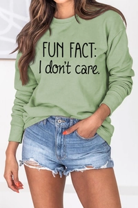 Detail of Fun Fact I Don't Care letter print on green crewneck long sleeve sweatshirt