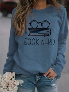 Detail of navy sweatshirt featuring Book Nerd text with glasses and book graphics