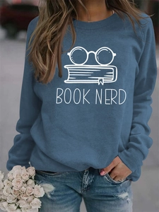 Close-up of blue crewneck sweatshirt with BOOK NERD print and raglan sleeves