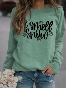 Detail of I Smell Snow print on mint green crewneck sweatshirt with snowflake design
