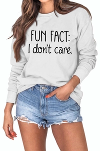 Close-up of Fun Fact I Don't Care slogan print on white crewneck sweatshirt