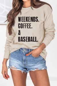 Detail of WEEKENDS COFFEE BASEBALL slogan on apricot crewneck oversized sweatshirt