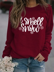 Detail view of burgundy I Smell Snow crewneck sweatshirt with snowflake pattern