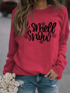 Detail of red crewneck sweatshirt featuring I smell snow text and snowflakes print