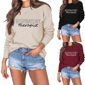 Detail view of respiratory therapist sweatshirts in beige, black, and burgundy colors