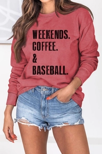 Detail of ribbed cuffs and hem on the brick red oversized graphic sweatshirt