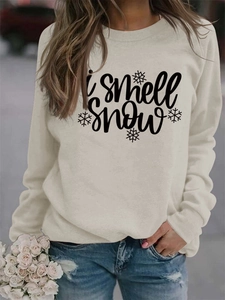 Detail of soft cotton I smell snow sweatshirt fabric with snowflake print for winter