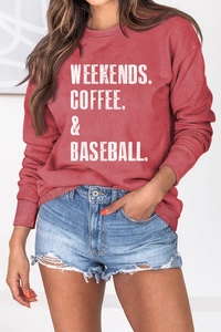 Detail of distressed lettering print on brick red long sleeve crewneck sweatshirt