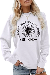 Detail of sunflower print and Be Kind slogan on white long sleeve crewneck sweatshirt