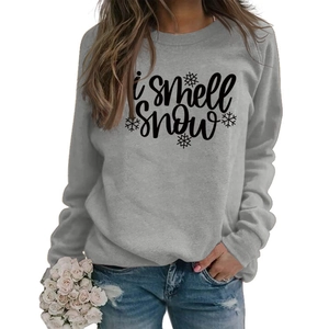 Detail of grey crewneck sweatshirt featuring black I smell SNOW text and snowflakes