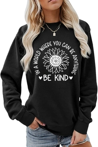 Close-up of sunflower print and Be Kind message on black long sleeve sweatshirt