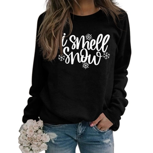 Detail of black crewneck sweatshirt with 'i smell snow' text and snowflake print