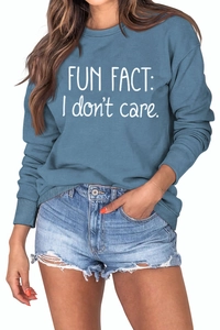 Detail of Fun Fact I Don't Care slogan print on blue crewneck long sleeve sweatshirt