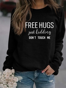 Detail of black long sleeve sweatshirt featuring white Free Hugs slogans and casual fit