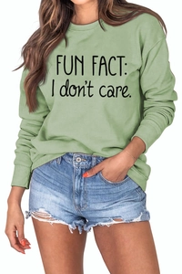 Detail of light green sweatshirt with Fun Fact I Don't Care slogan and crew neck
