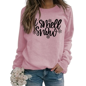 Detail of light pink crewneck sweatshirt featuring black I smell snow print and snowflake