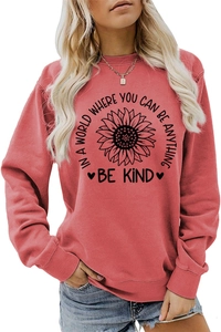 Detail of red crewneck sweatshirt with sunflower print and Be Kind slogan for women