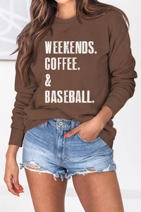 Detail of loose fit brown crewneck sweatshirt featuring white artistic letter printing
