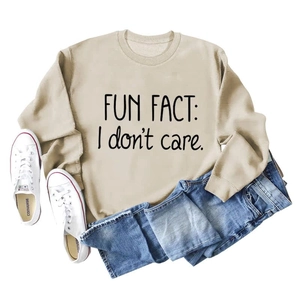 Flat lay of beige crewneck sweatshirt with black Fun Fact I Don't Care print text