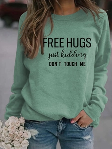 Detail of Free Hugs slogan print on sage green crewneck long sleeve sweatshirt