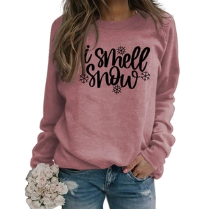 Detail of I SMELL SNOW text and snowflake print on dusty rose crewneck sweatshirt