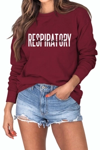 Détail du lettrage blanc 'RESPIRATORY therapist' sur le sweat-shirt bordeaux à col rond